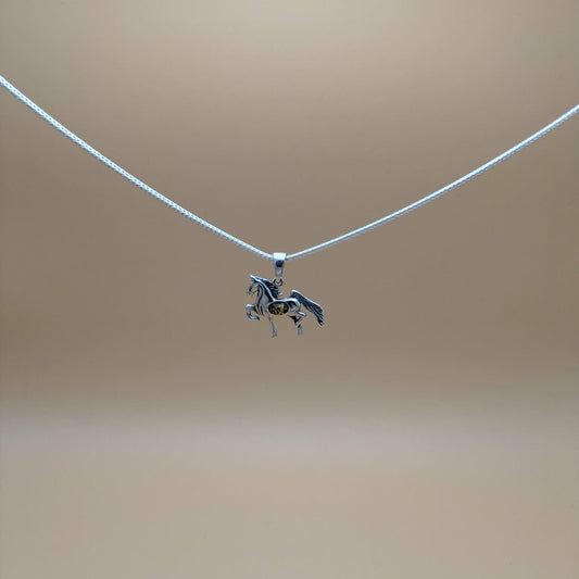 Silver pendant shaped as a horse with green amber
