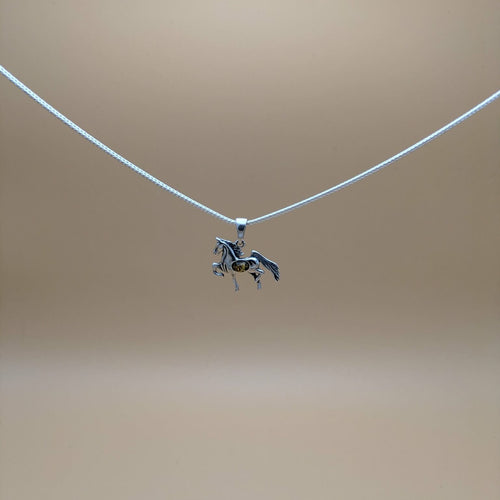 Silver pendant shaped as a  horse with green amber