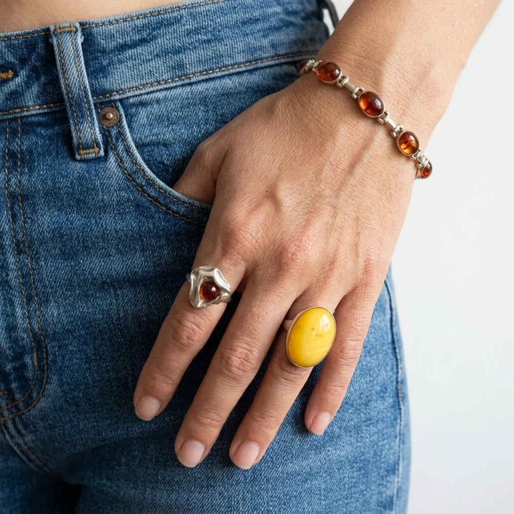 Amber jewelry, gold bracelet and silver rings. 
