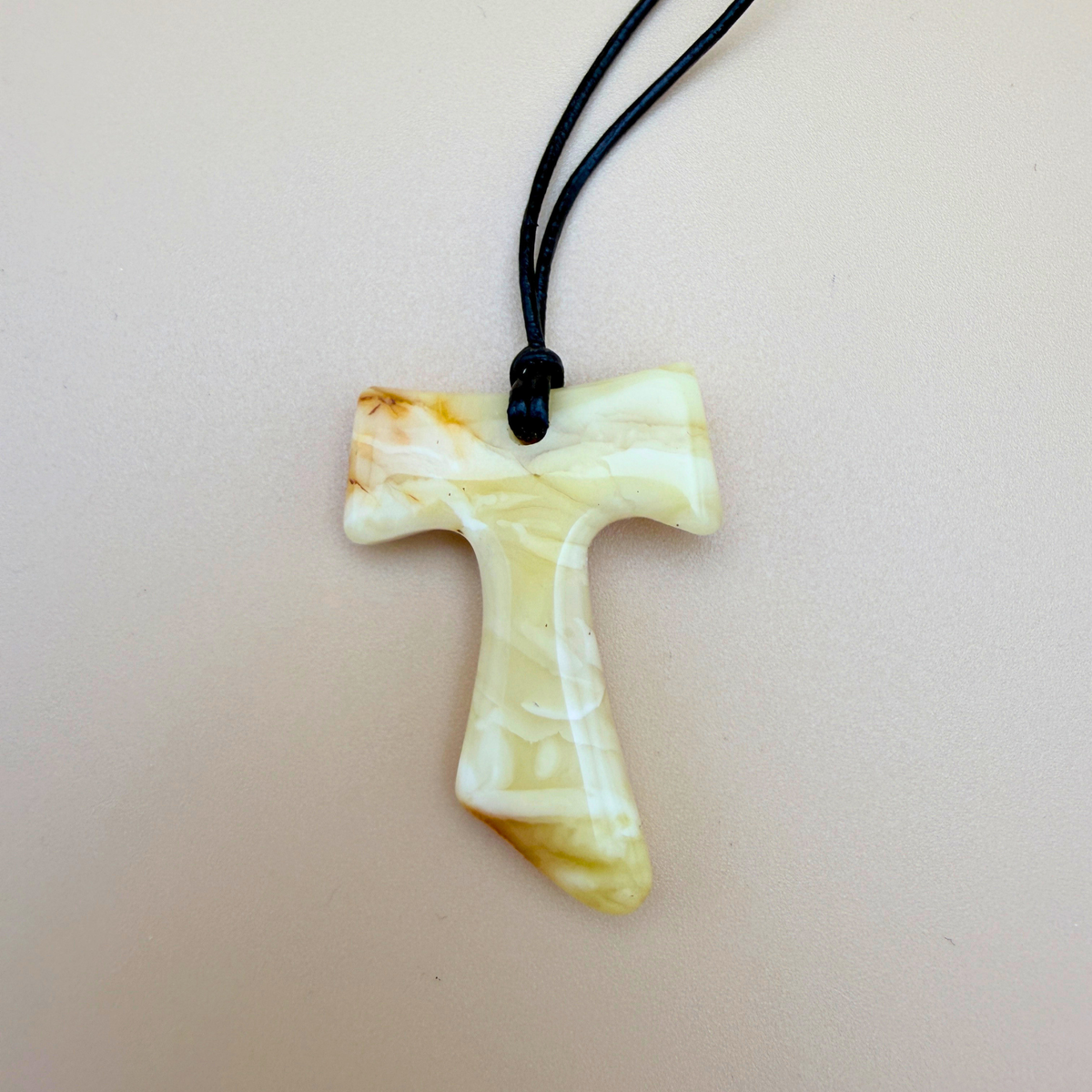 Tau cross with black leather cord