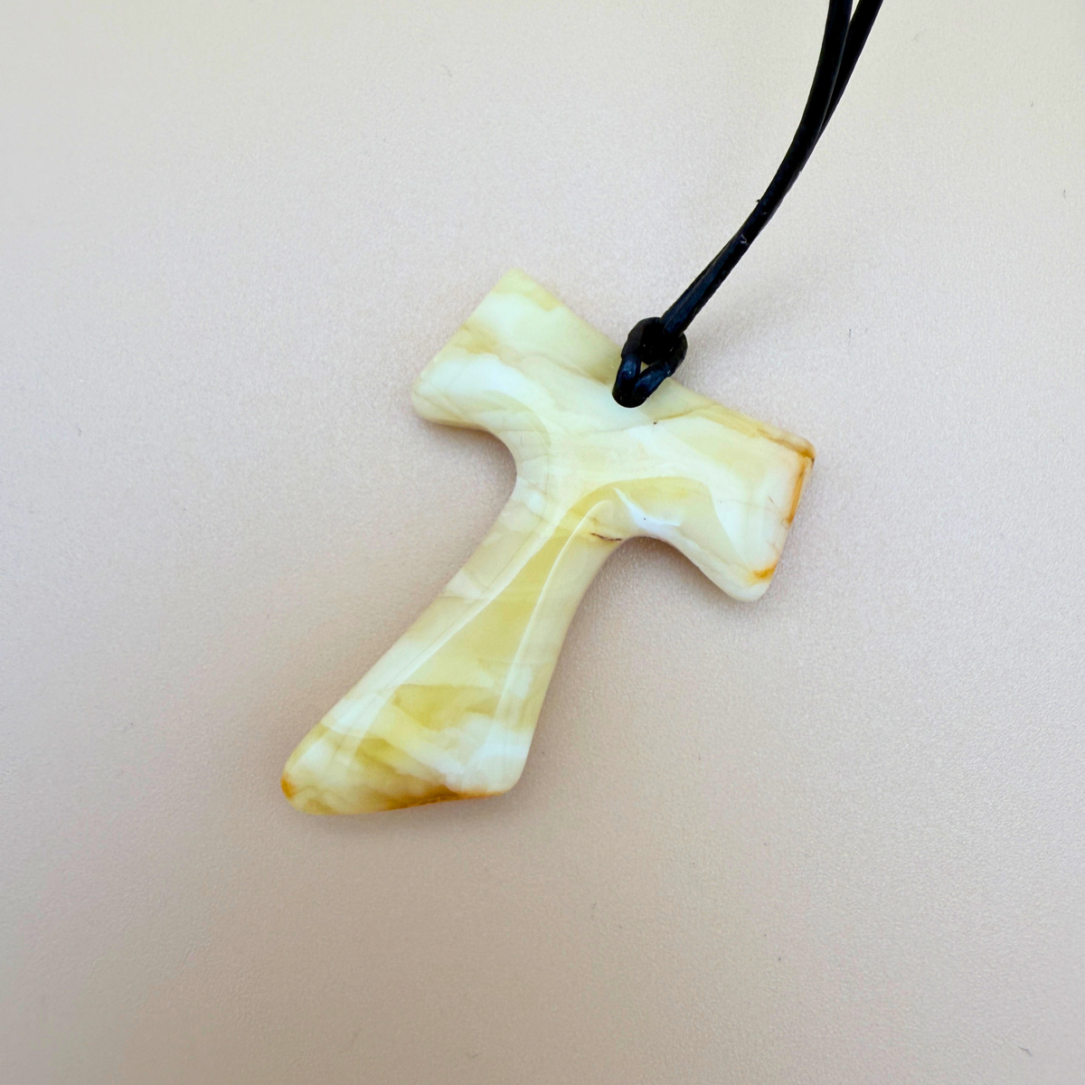 Tau cross with black leather cord