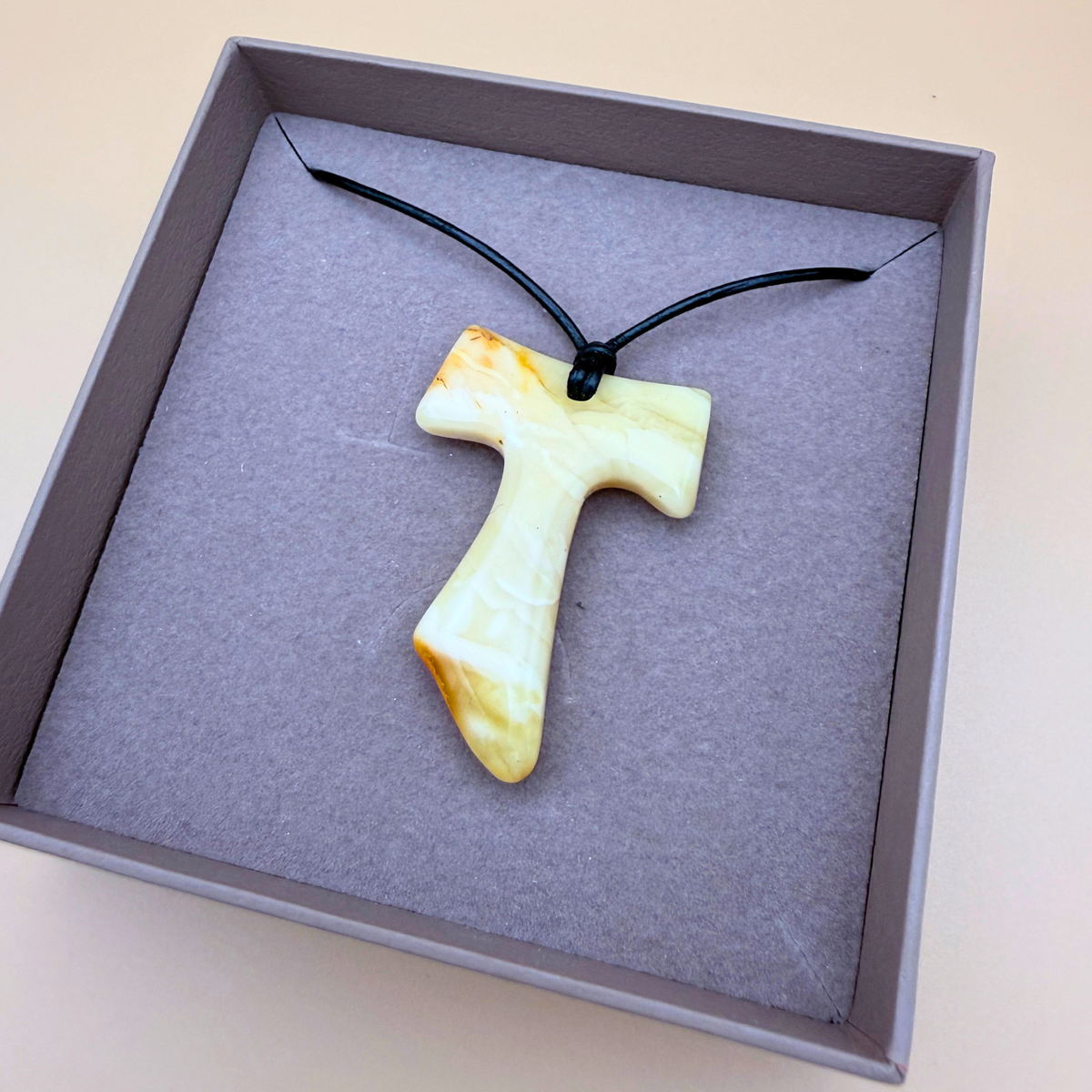 Tau cross with black leather cord