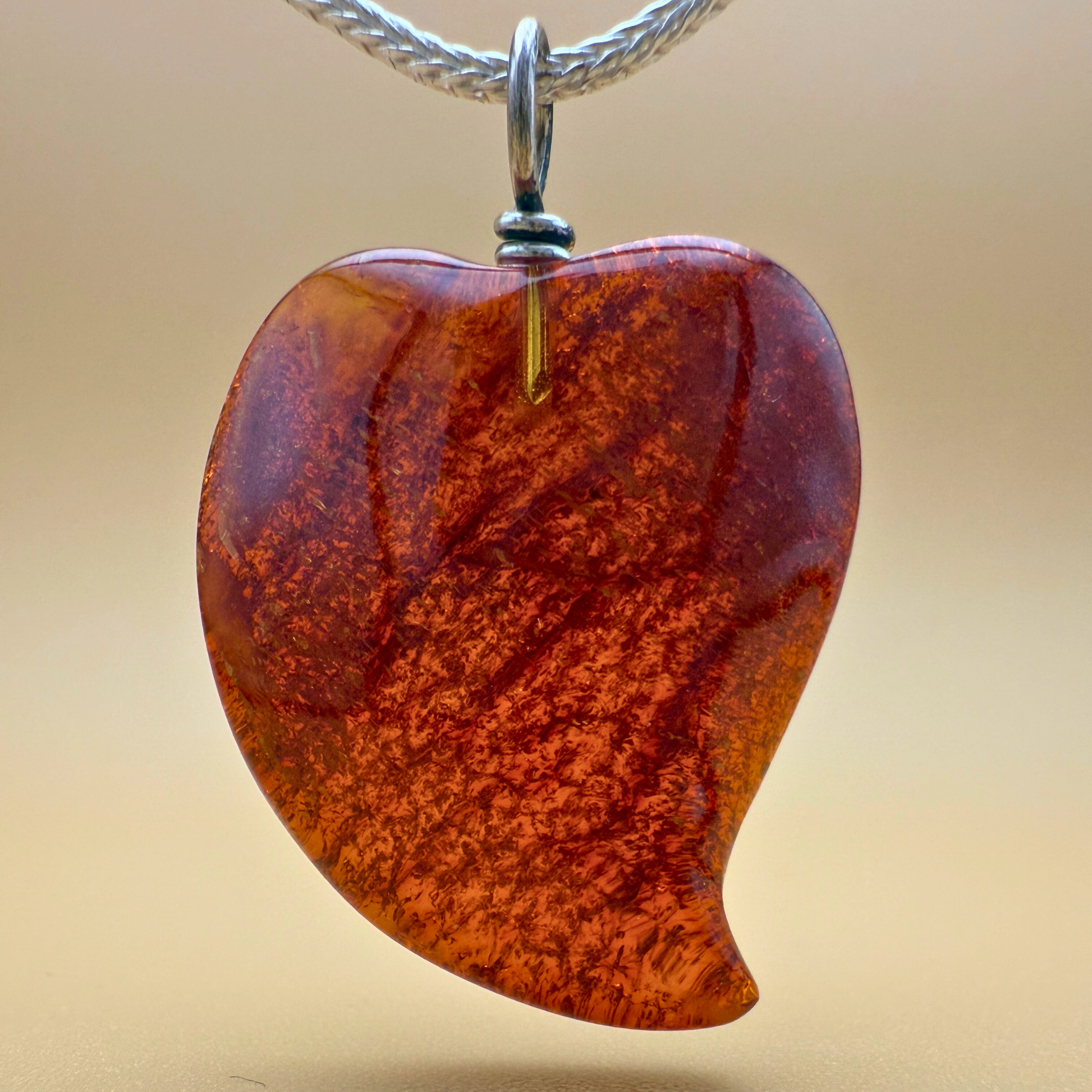 Amber heart pendant in wine red with silver bail Ravgaard design